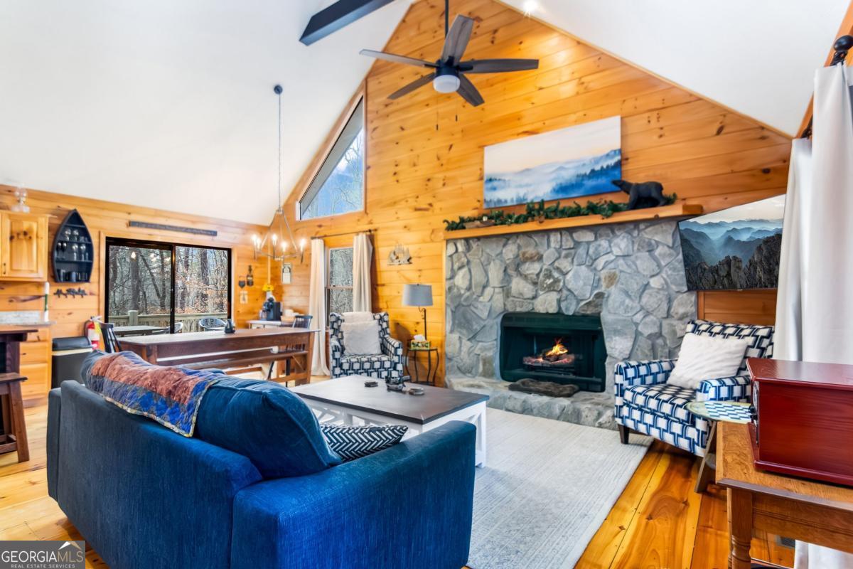 174 Seneca Way, Unit 116 Ellijay, GA 30540 - Photo 8 of 39 a living room with furniture a fireplace and a floor to ceiling window