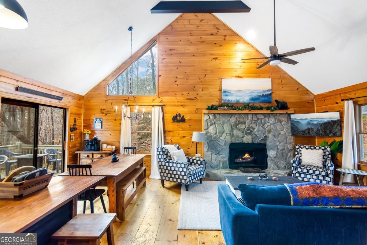 174 Seneca Way, Unit 116 Ellijay, GA 30540 - Photo 10 of 39 a living room with patio furniture and a fireplace