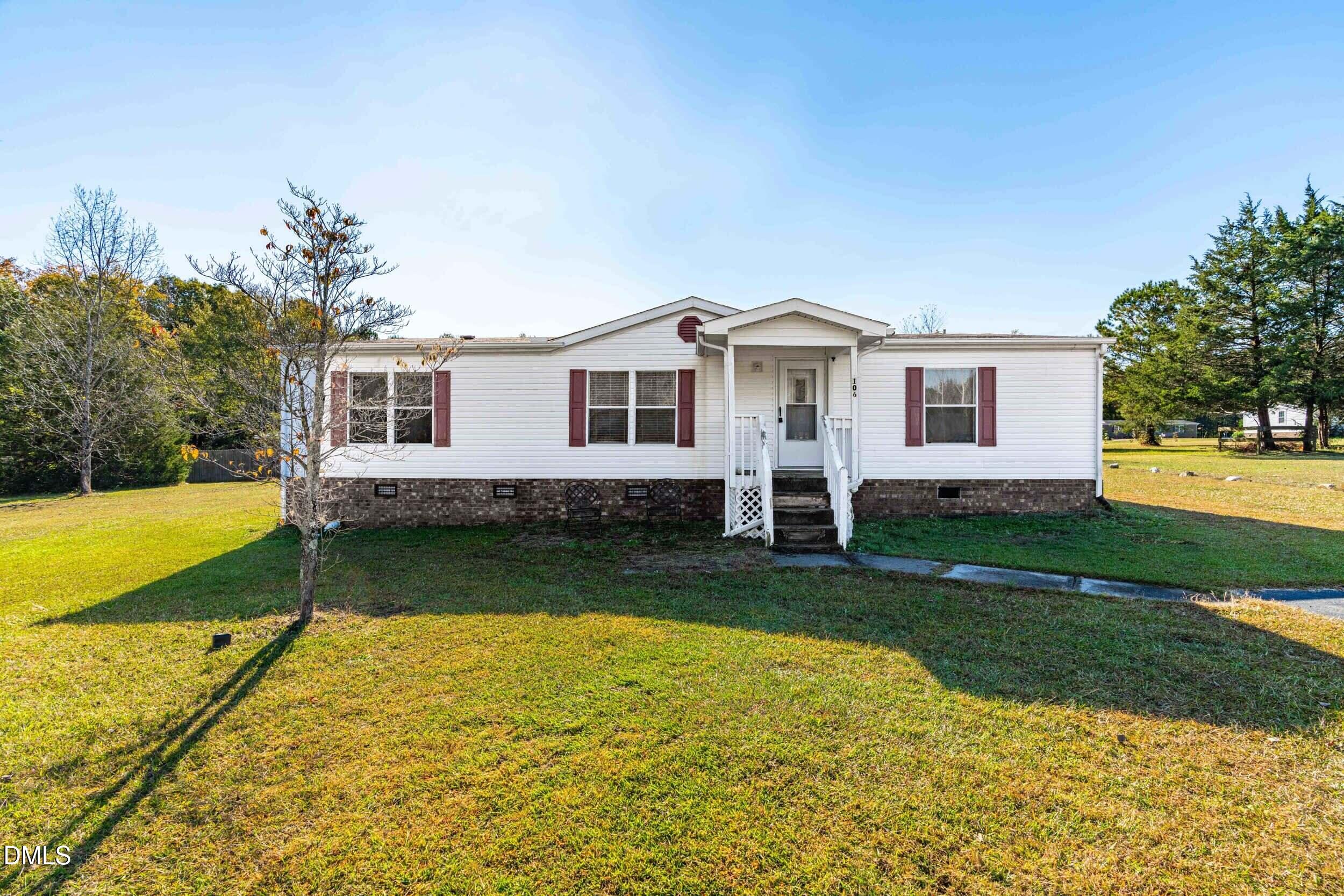 106 Roe Lane Clayton, NC 27527 - Photo 1 of 24 a front view of a house with garden