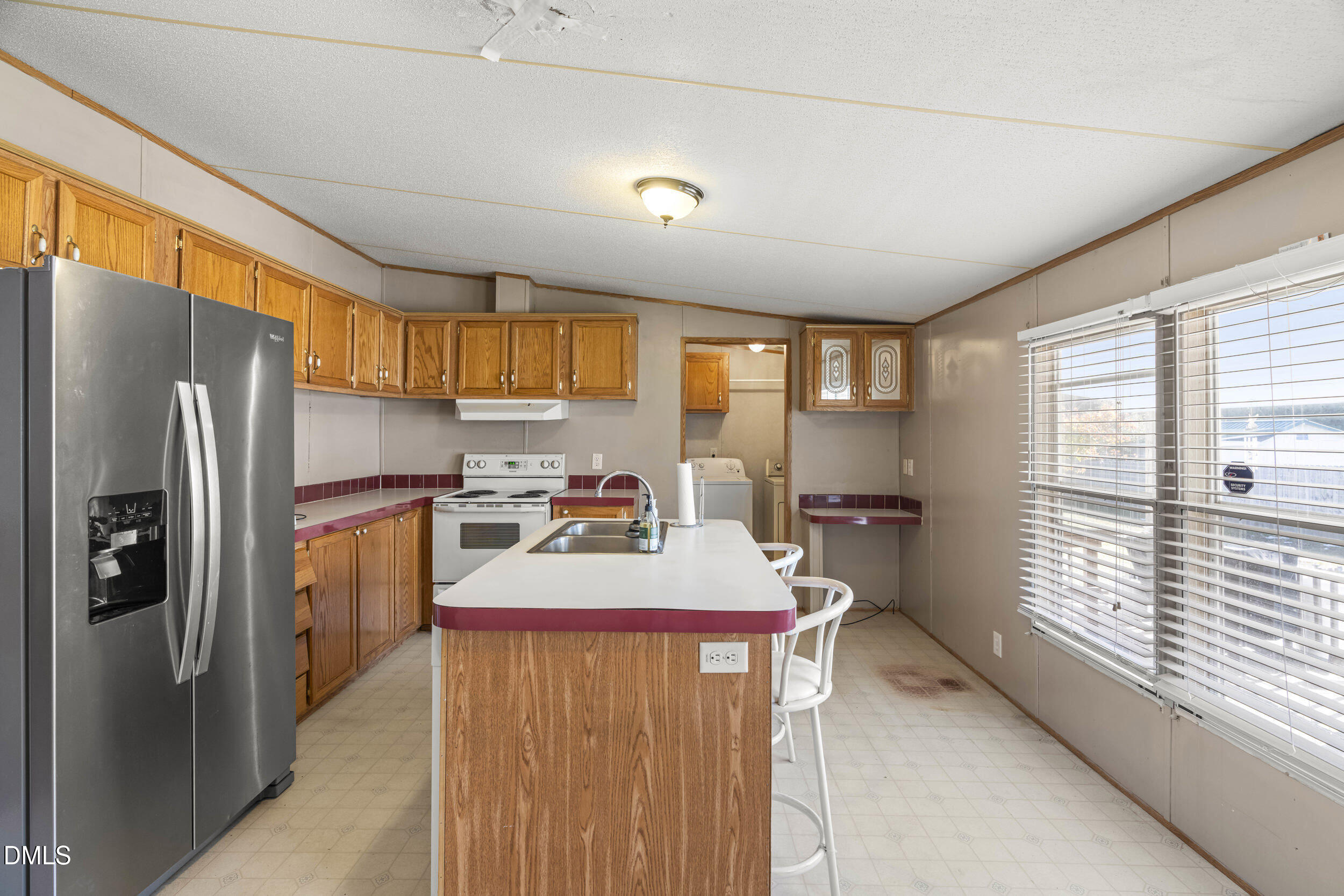 106 Roe Lane Clayton, NC 27527 - Photo 11 of 24 a kitchen with refrigerator and window