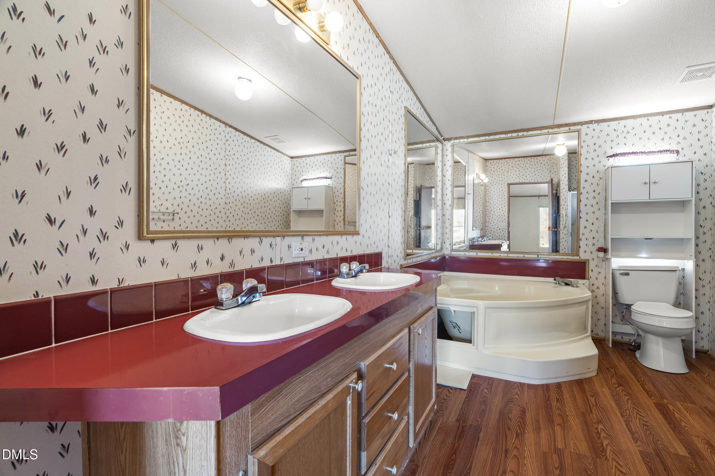 106 Roe Lane Clayton, NC 27527 - Photo 15 of 24 a bathroom with a sink and a mirror