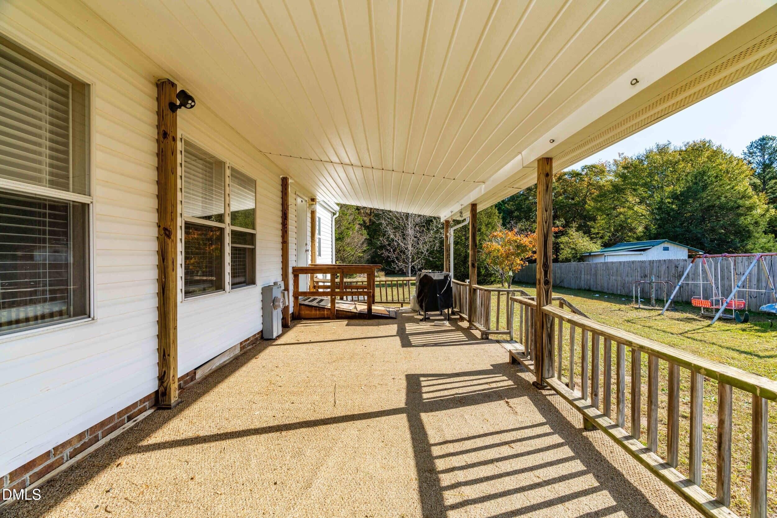 106 Roe Lane Clayton, NC 27527 - Photo 20 of 24 a view of a patio with a table and chairs