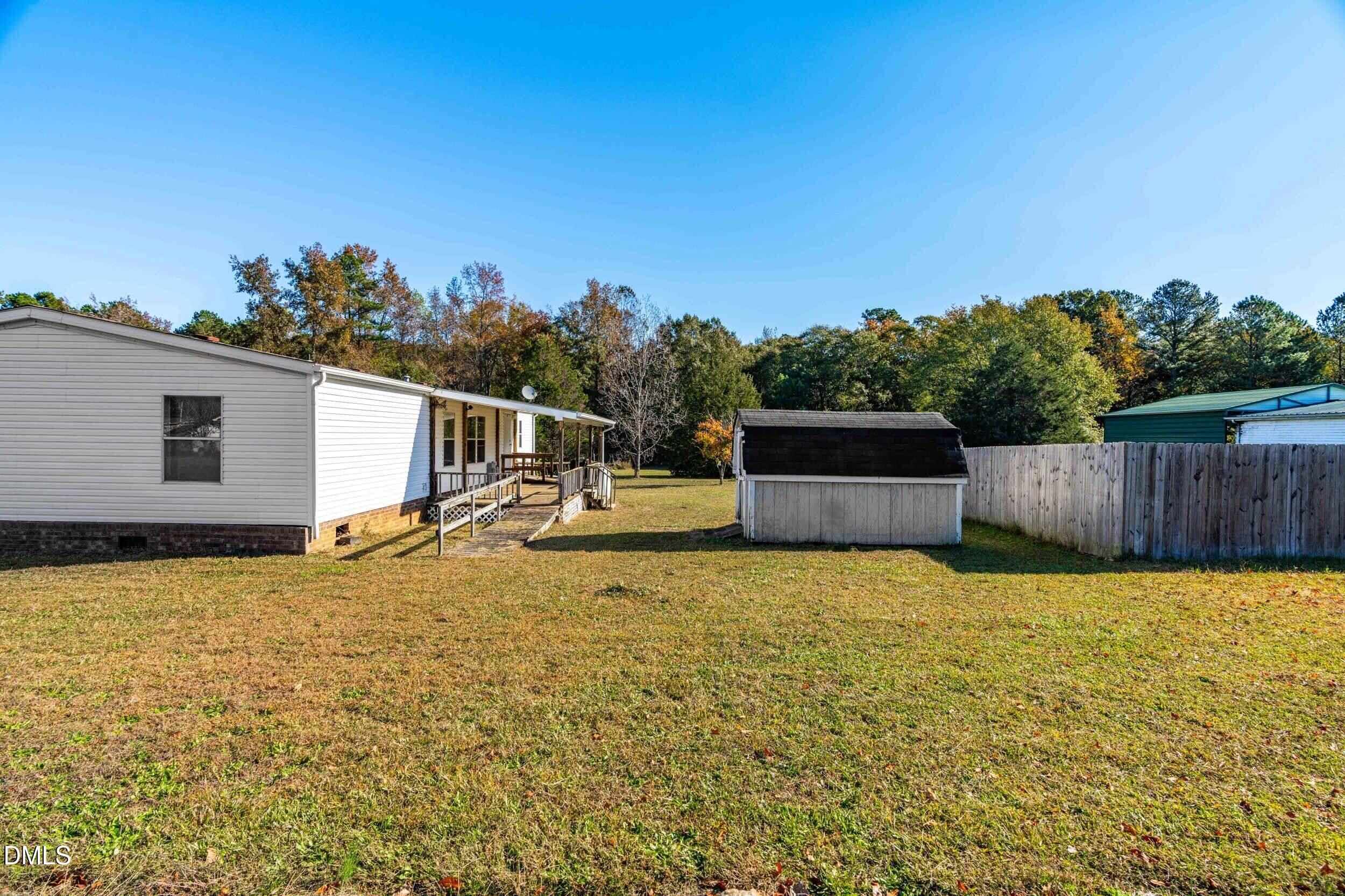 106 Roe Lane Clayton, NC 27527 - Photo 21 of 24 a view of a house with a backyard
