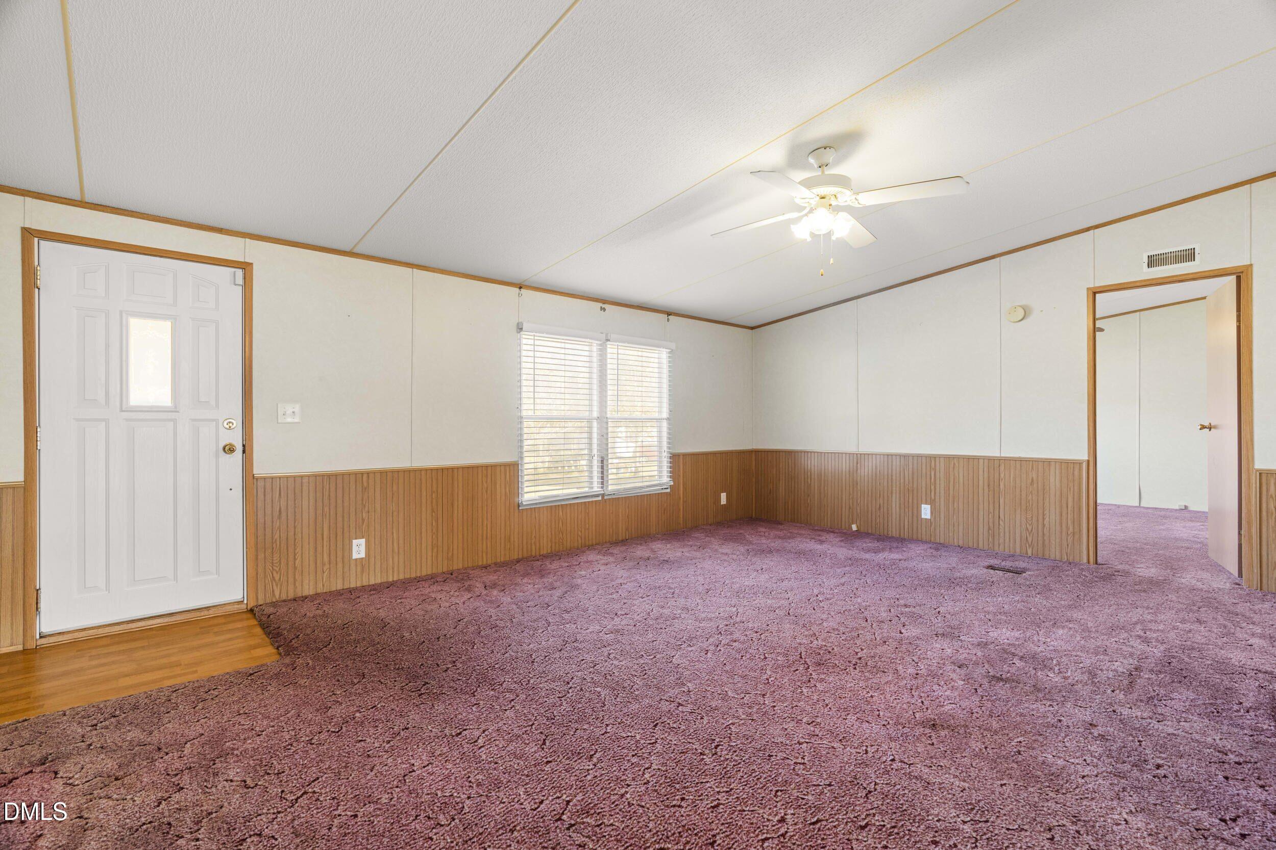 106 Roe Lane Clayton, NC 27527 - Photo 5 of 24 an empty room with windows and fan