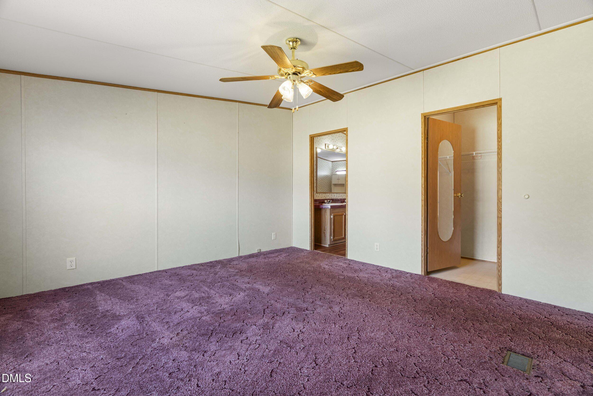 106 Roe Lane Clayton, NC 27527 - Photo 6 of 24 a view of a big room with a chandelier fan and a ceiling fan