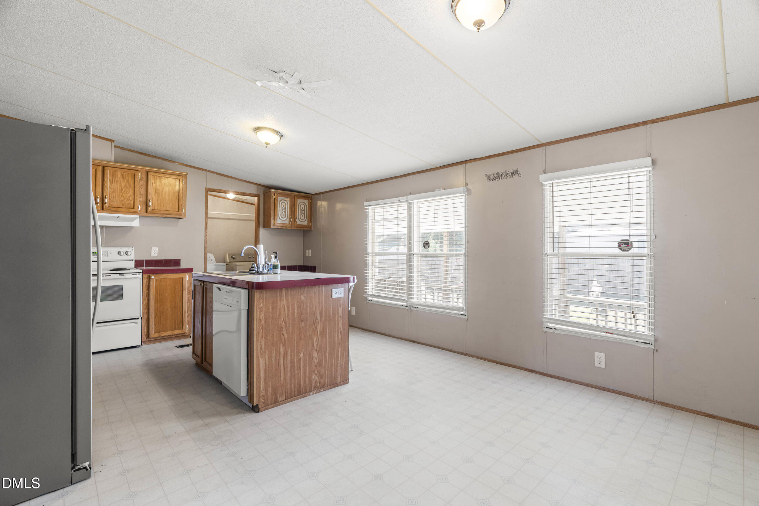 106 Roe Lane Clayton, NC 27527 - Photo 9 of 24 a room with kitchen island and windows