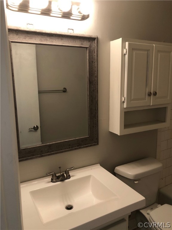 11636 River Road Chesterfield, VA 23838 - Photo 23 of 50 a bathroom with a sink a toilet and mirror