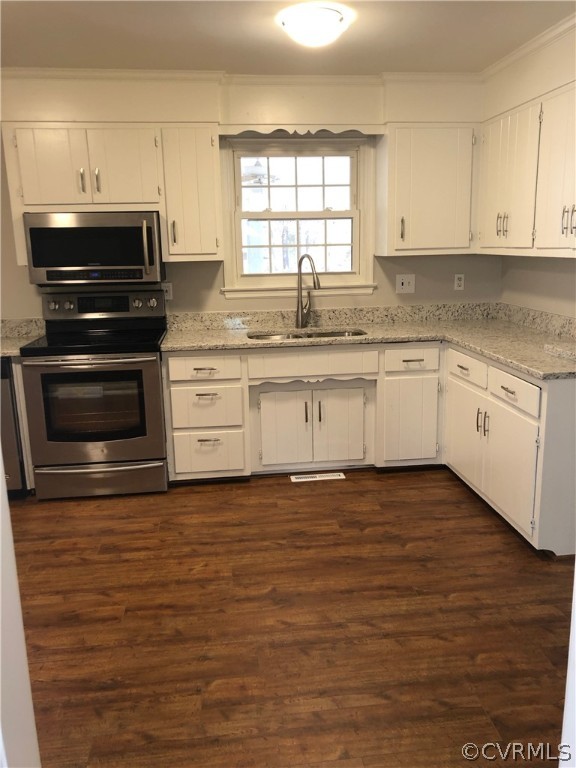 11636 River Road Chesterfield, VA 23838 - Photo 7 of 50 a kitchen with stainless steel appliances granite countertop a stove a sink and white cabinets