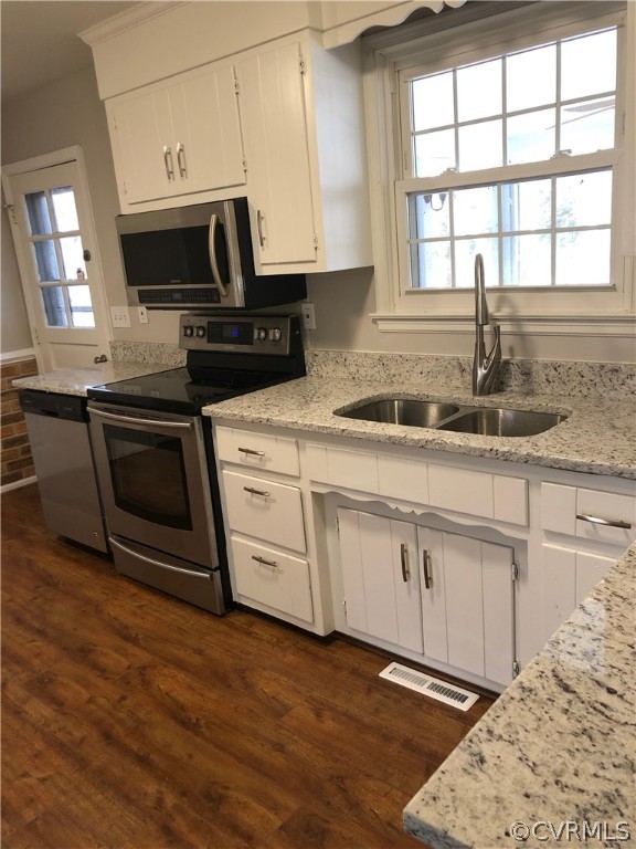 11636 River Road Chesterfield, VA 23838 - Photo 10 of 50 a kitchen with stainless steel appliances granite countertop a sink a stove a microwave and wooden cabinets