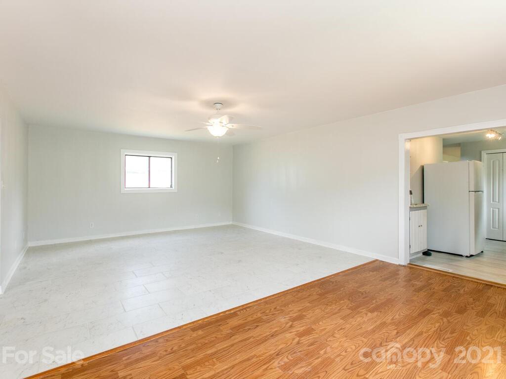 39 Sellers Road Clyde, NC 28721 - Photo 22 of 33 a view of an empty room with wooden floor and a window
