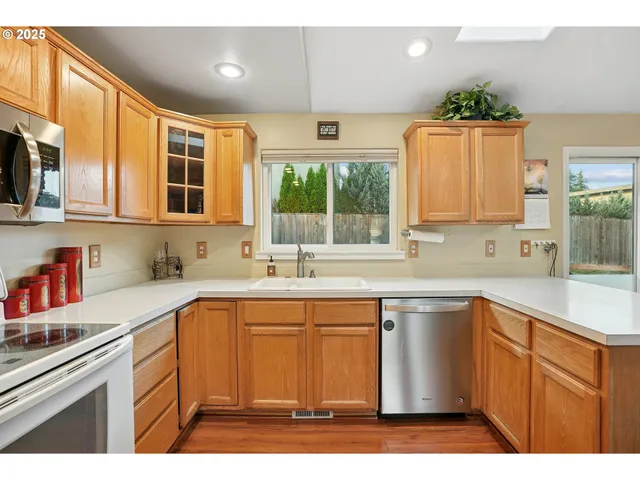 a kitchen with a sink window and cabinets