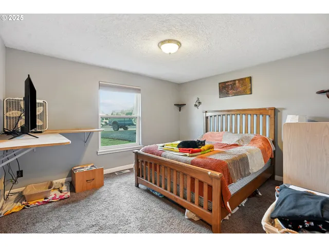 a bedroom with bed and a window