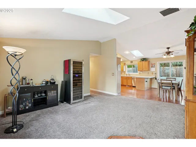 a view of a livingroom with furniture and an empty room
