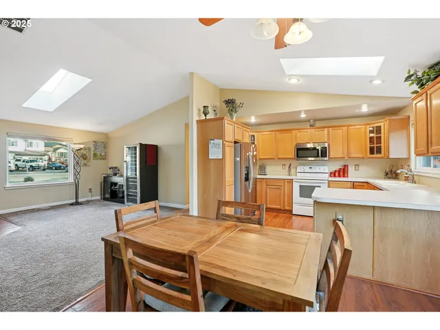 a room with kitchen island a sink and a refrigerator