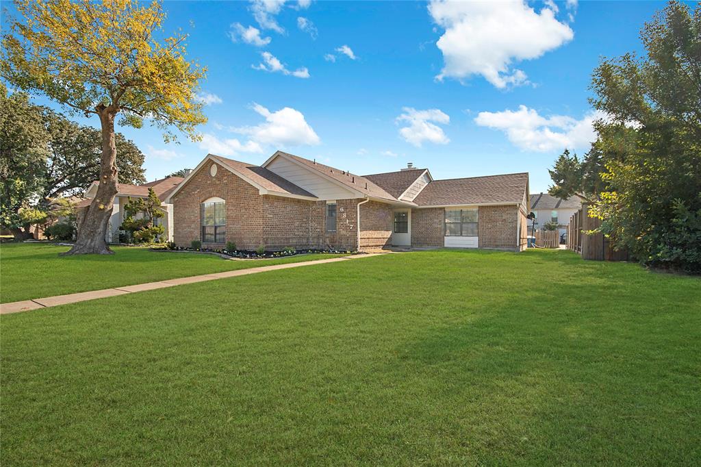 6817 Anderson Drive The Colony, TX 75056 - Photo 1 of 21 a front view of house with garden
