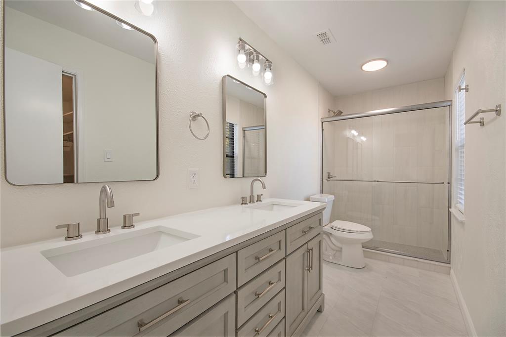 6817 Anderson Drive The Colony, TX 75056 - Photo 14 of 21 a bathroom with a sink a toilet and a mirror