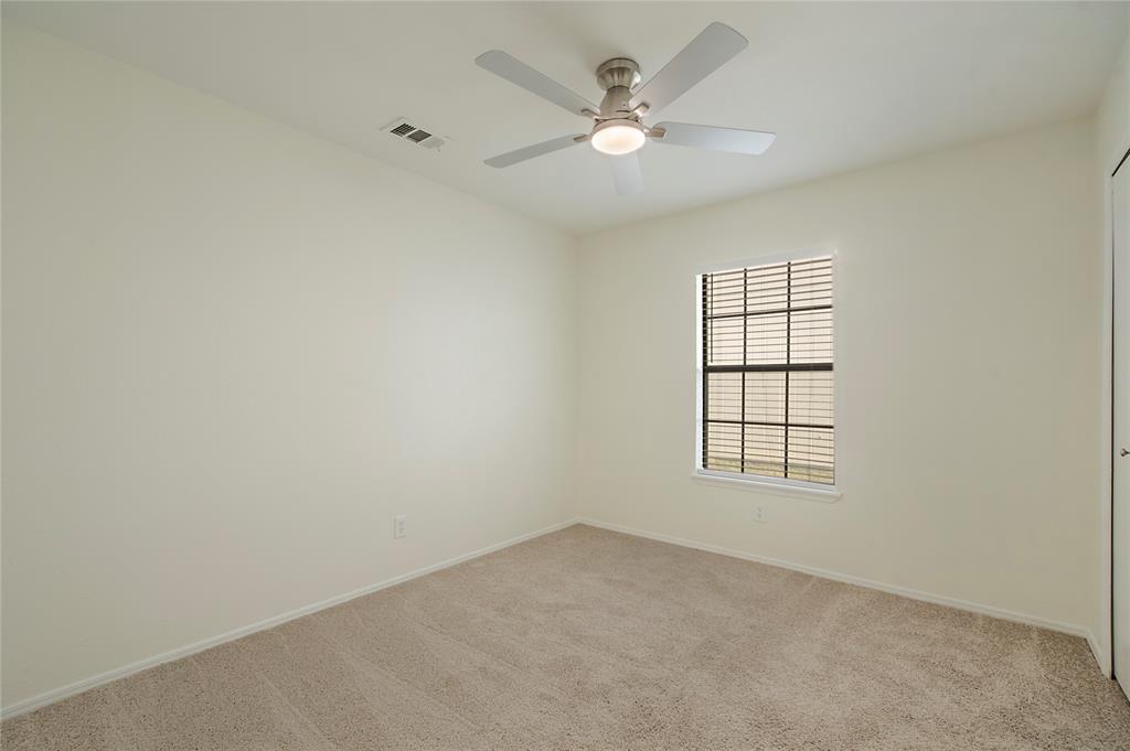 6817 Anderson Drive The Colony, TX 75056 - Photo 16 of 21 an empty room with windows and ceiling fan