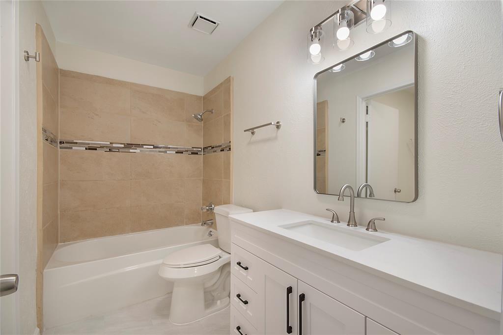 6817 Anderson Drive The Colony, TX 75056 - Photo 17 of 21 a bathroom with a sink a toilet and shower