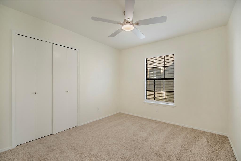 6817 Anderson Drive The Colony, TX 75056 - Photo 19 of 21 an empty room with windows and ceiling fan