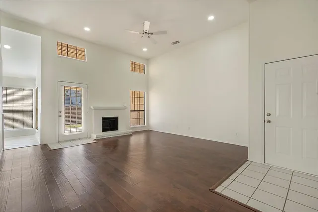 an empty room with wooden floor and fireplace