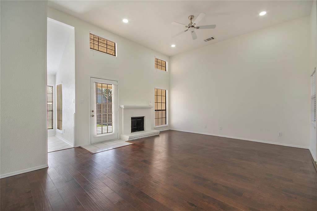 6817 Anderson Drive The Colony, TX 75056 - Photo 6 of 21 a view of empty room with wooden floor and fireplace