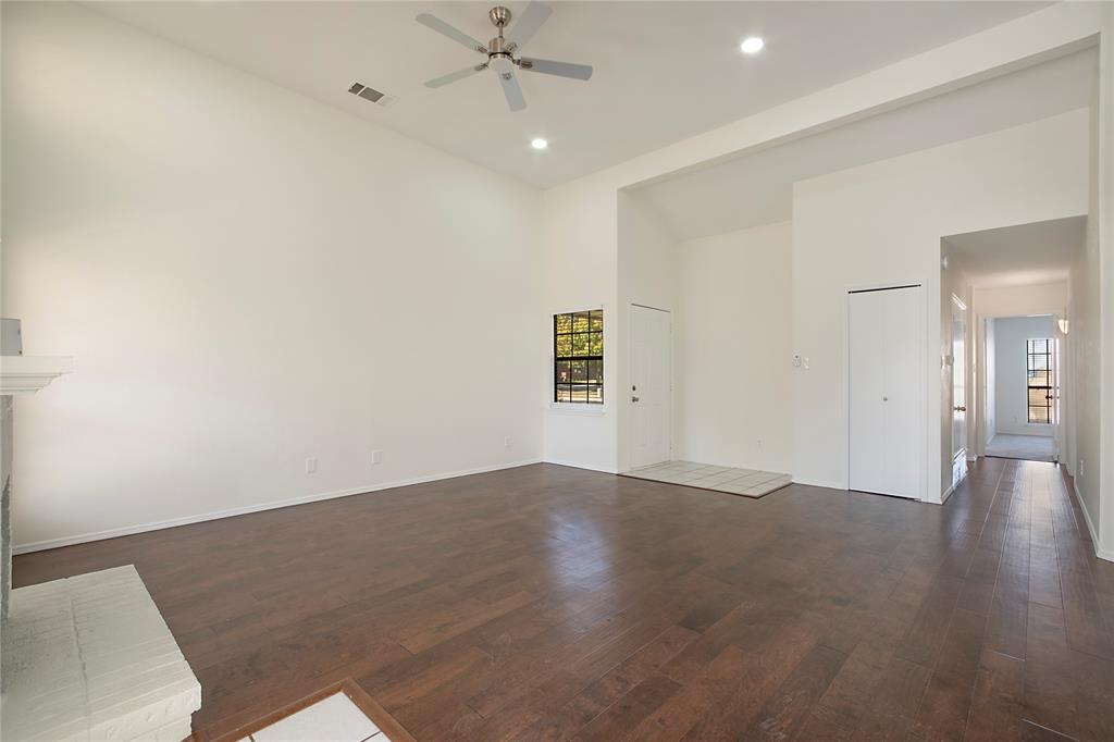 6817 Anderson Drive The Colony, TX 75056 - Photo 7 of 21 an empty room with wooden floor and windows
