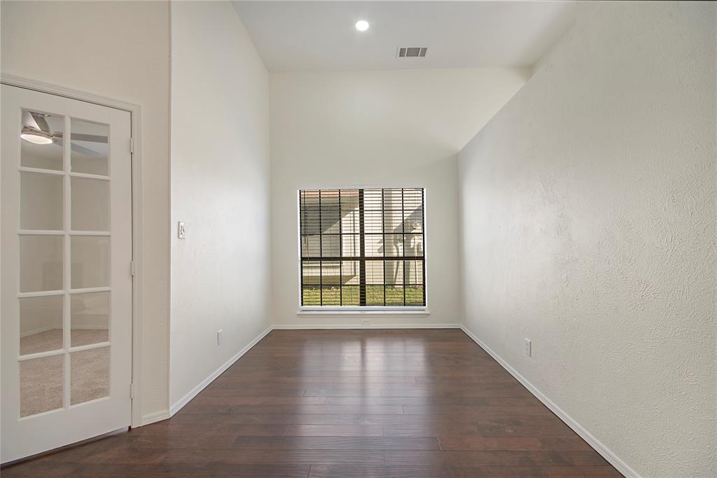 6817 Anderson Drive The Colony, TX 75056 - Photo 9 of 21 an empty room with wooden floor and windows