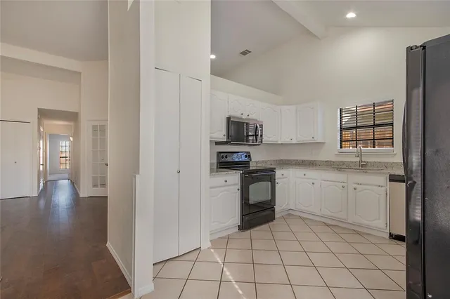 a kitchen with a sink and white cabinets
