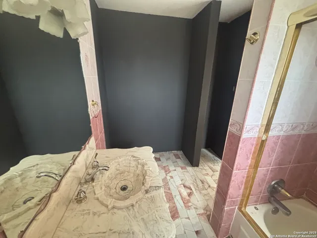 a bathroom with a sink and mirror