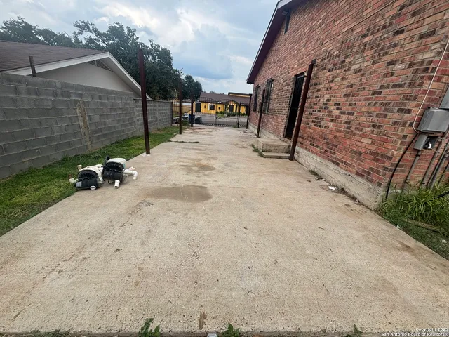 a view of a patio with table and chairs with wooden floor and fence