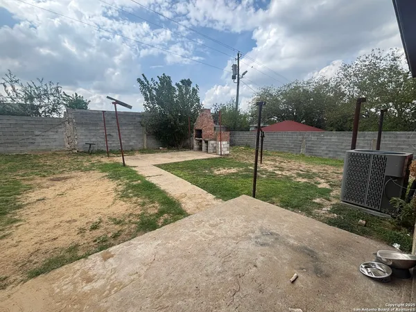 a backyard of a house with table and chairs