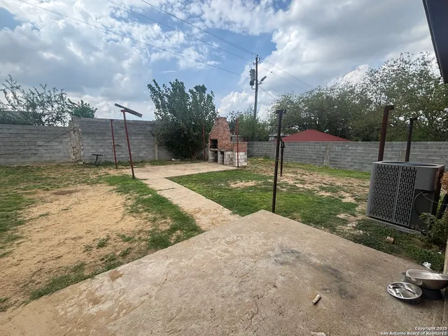 a backyard of a house with table and chairs