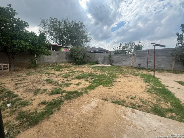 a view of hallway with windows and refrigerator