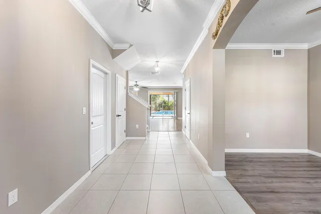 a view of a hallway with wooden floor and staircase