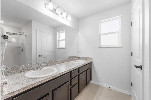 a bathroom with a glass shower door