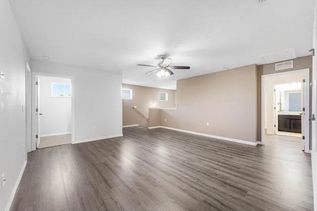 a view of an empty room with wooden floor