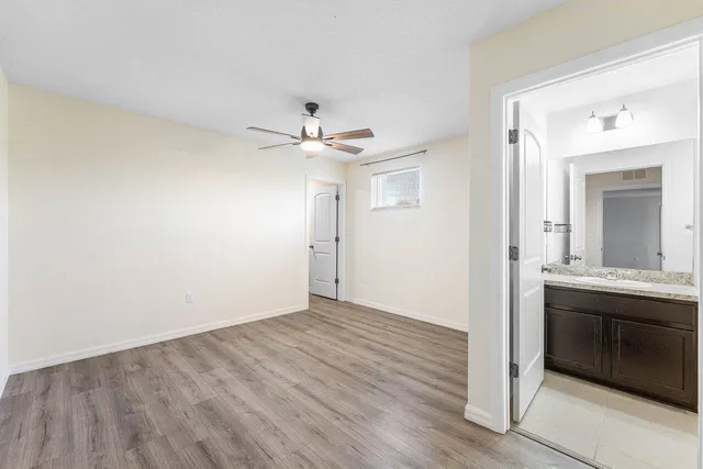 a bathroom with a granite countertop sink toilet a mirror and shower
