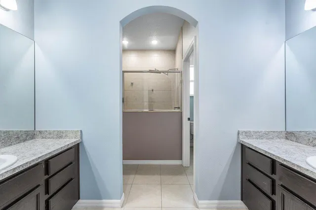 a bathroom with a shower and a window