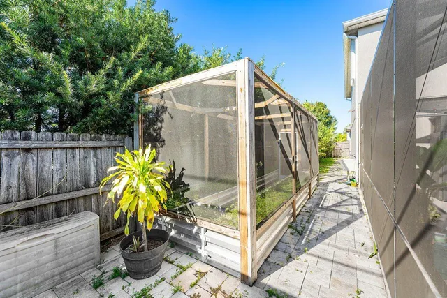 a view of a yard with wooden fence