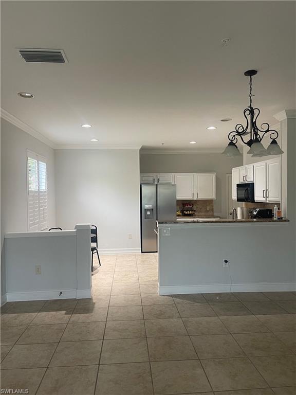 884 Hampton Circle, Unit 159 Naples, FL 34105 - Photo 4 of 28 a view of kitchen with cabinets and refrigerator