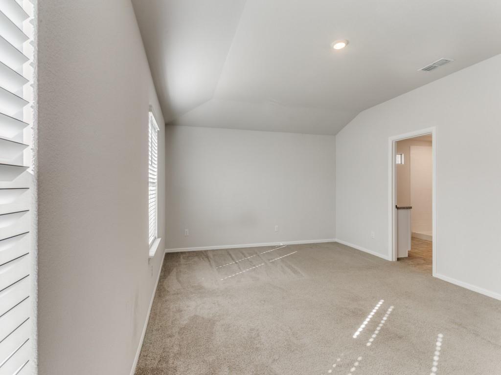 233 Abingdon Street Azle, TX 76020 - Photo 11 of 12 Empty room featuring light carpet and vaulted ceiling