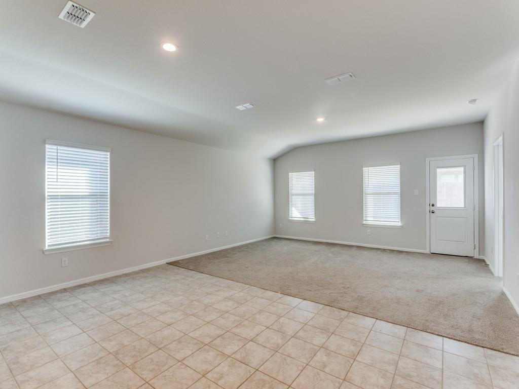 233 Abingdon Street Azle, TX 76020 - Photo 4 of 12 Empty room featuring light carpet, plenty of natural light, lofted ceiling, and recessed lighting
