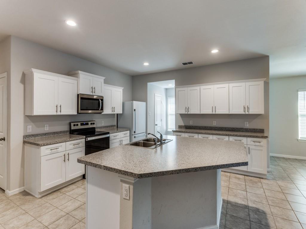 233 Abingdon Street Azle, TX 76020 - Photo 5 of 12 Kitchen featuring stainless steel appliances, white cabinets, light tile patterned floors, a kitchen island with sink, and recessed lighting