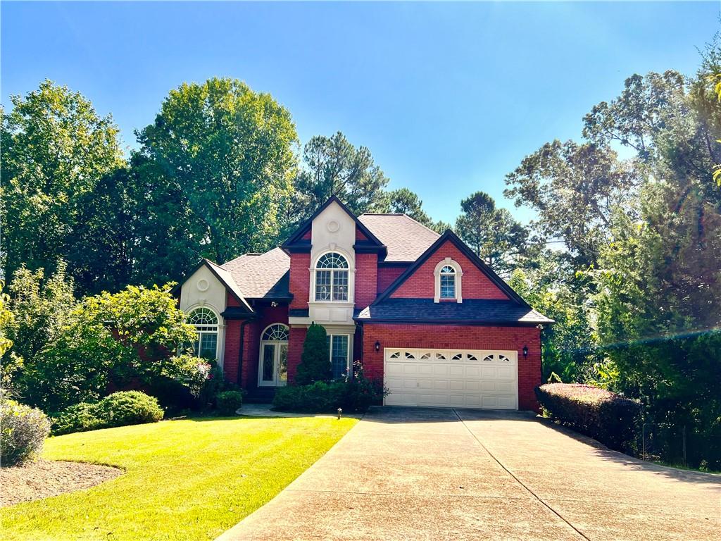 a front view of a house with a yard and garage