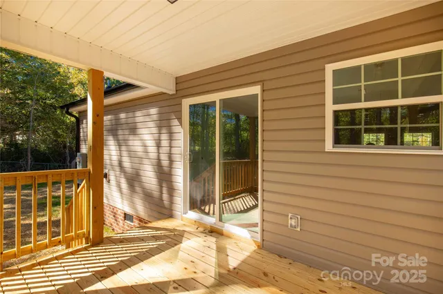 a view of a balcony with wooden floor