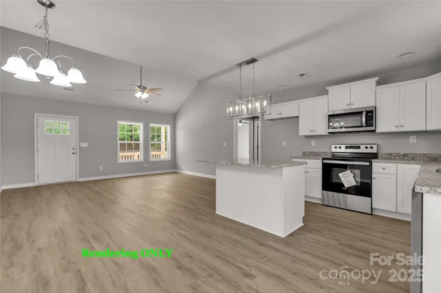 a large kitchen with hardwood floor a window and appliances