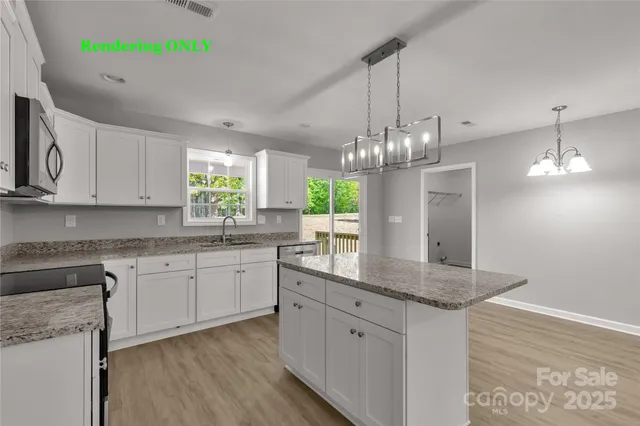 a kitchen with kitchen island granite countertop a center island a sink cabinets and wooden floor