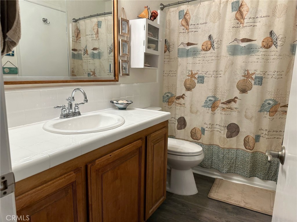 9051 Cobblestone Lane, Unit 40 Cypress, CA 90630 - Photo 11 of 38 a bathroom with a sink toilet and shower