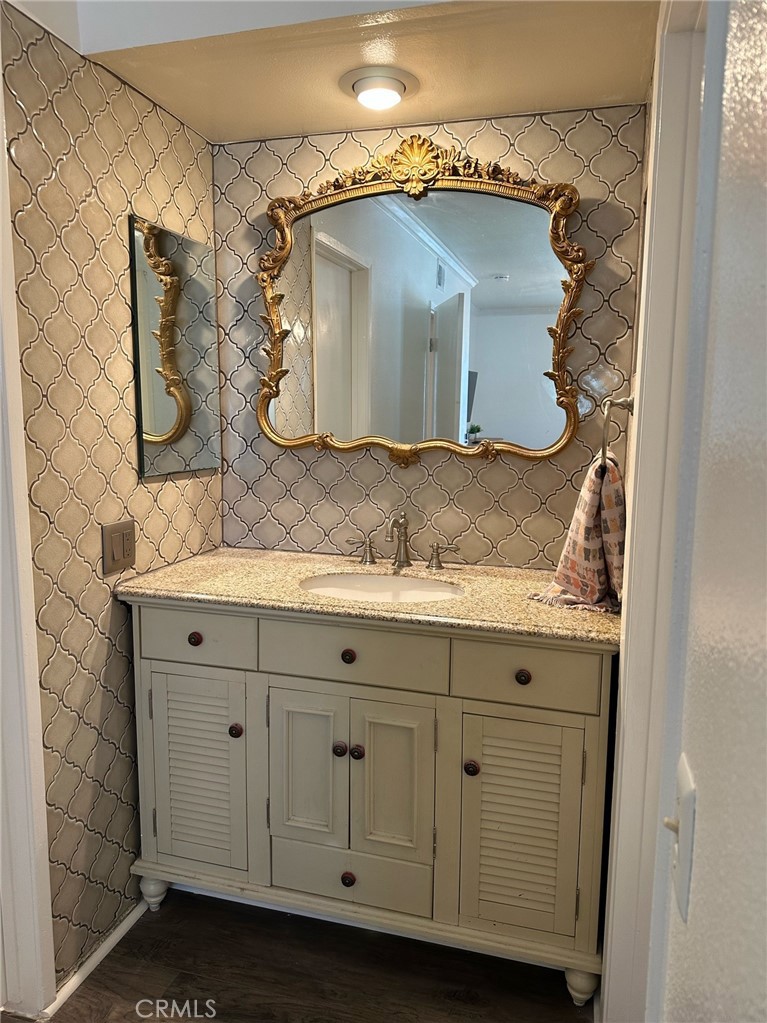 9051 Cobblestone Lane, Unit 40 Cypress, CA 90630 - Photo 12 of 38 a bathroom with a sink and mirror