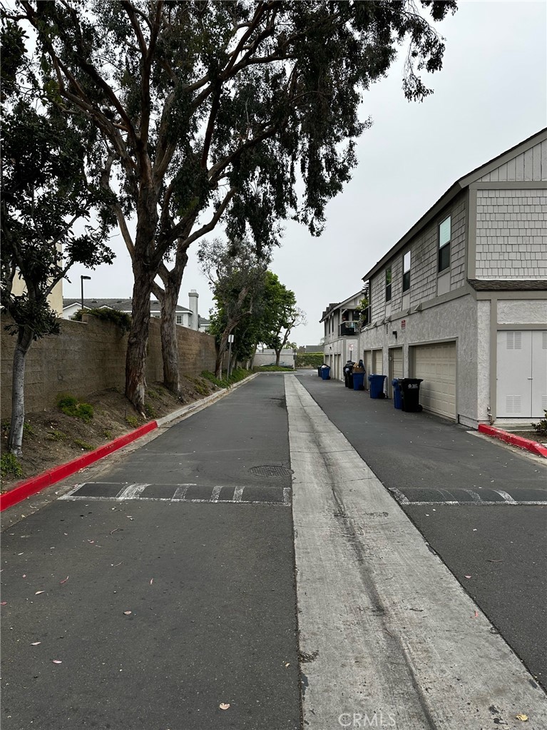 9051 Cobblestone Lane, Unit 40 Cypress, CA 90630 - Photo 19 of 38 a city view with tall buildings and cars parked on road